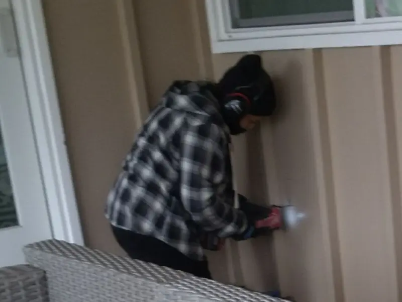 Professional electrician installing an exterior outlet in Shelby